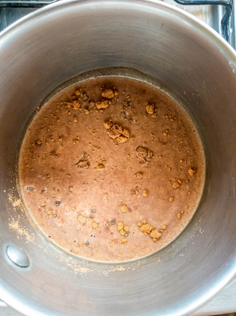 A picture of powders in bone broth in small saucepan.