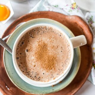 A picture of bone broth coffee latte with cinnamon dust as garnish.