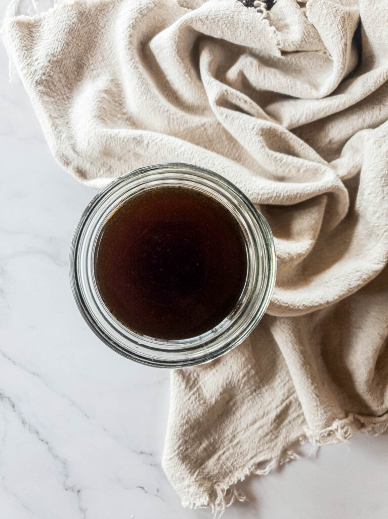 A picture of final keto cold brew liquid in glass jar.