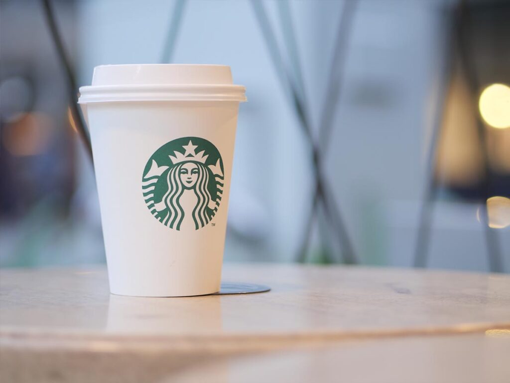 A sugar-free Starbucks coffee cup sits on a table.
