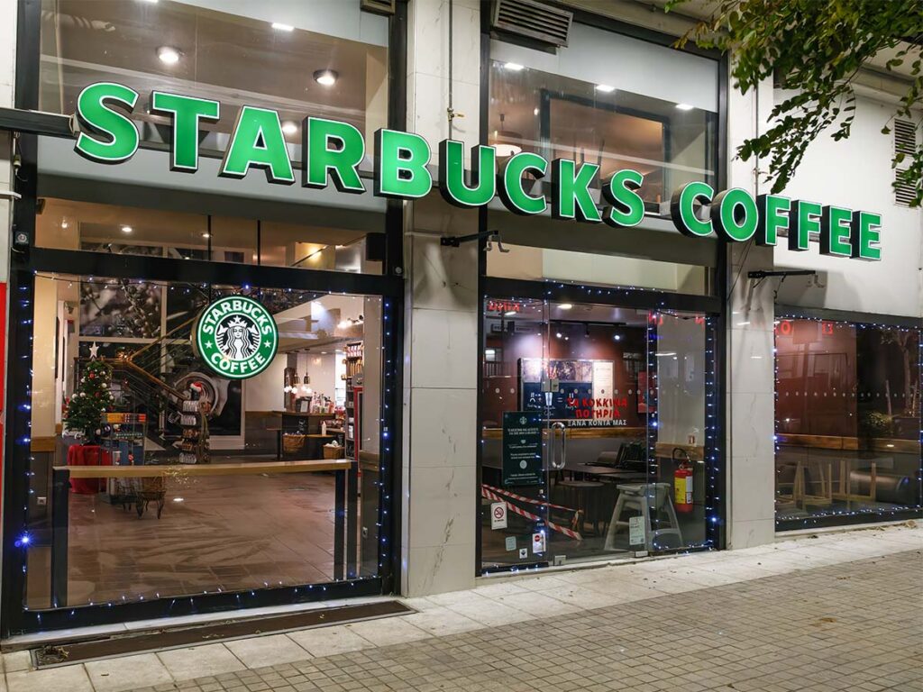 At night, a brightly illuminated Starbucks coffee shop offers a variety of sugar free drinks.