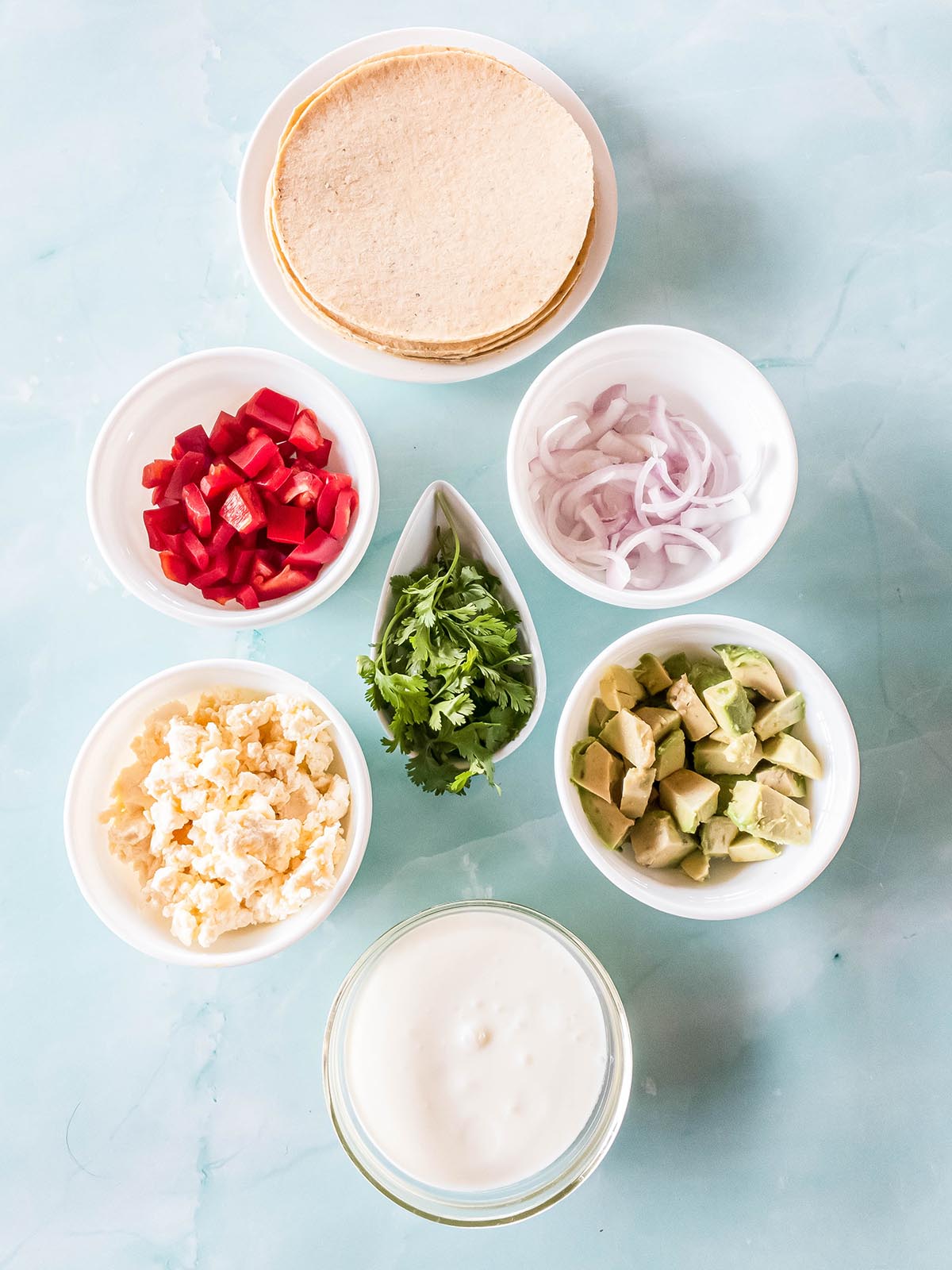 A picture of the best taco fixings in individual bowls.