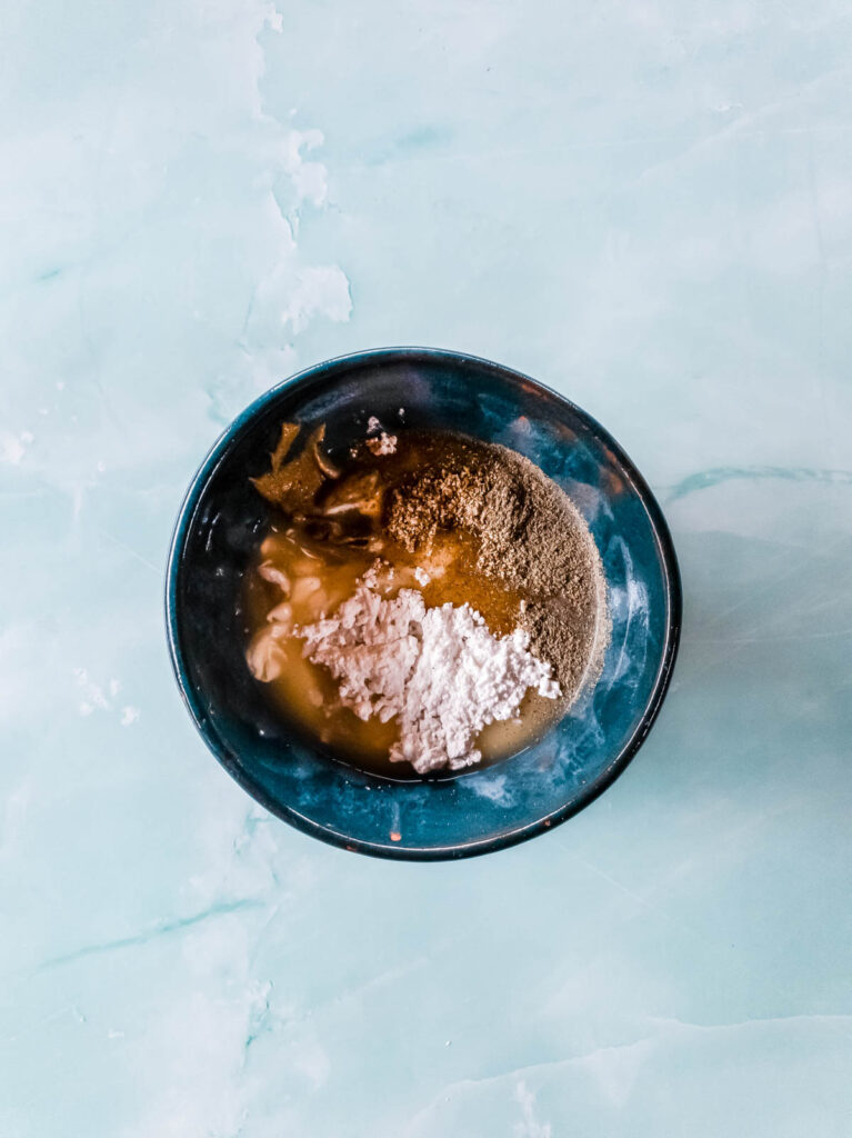 A picture of coleslaw dressing ingreidents together in small ceramic mixing bowl.