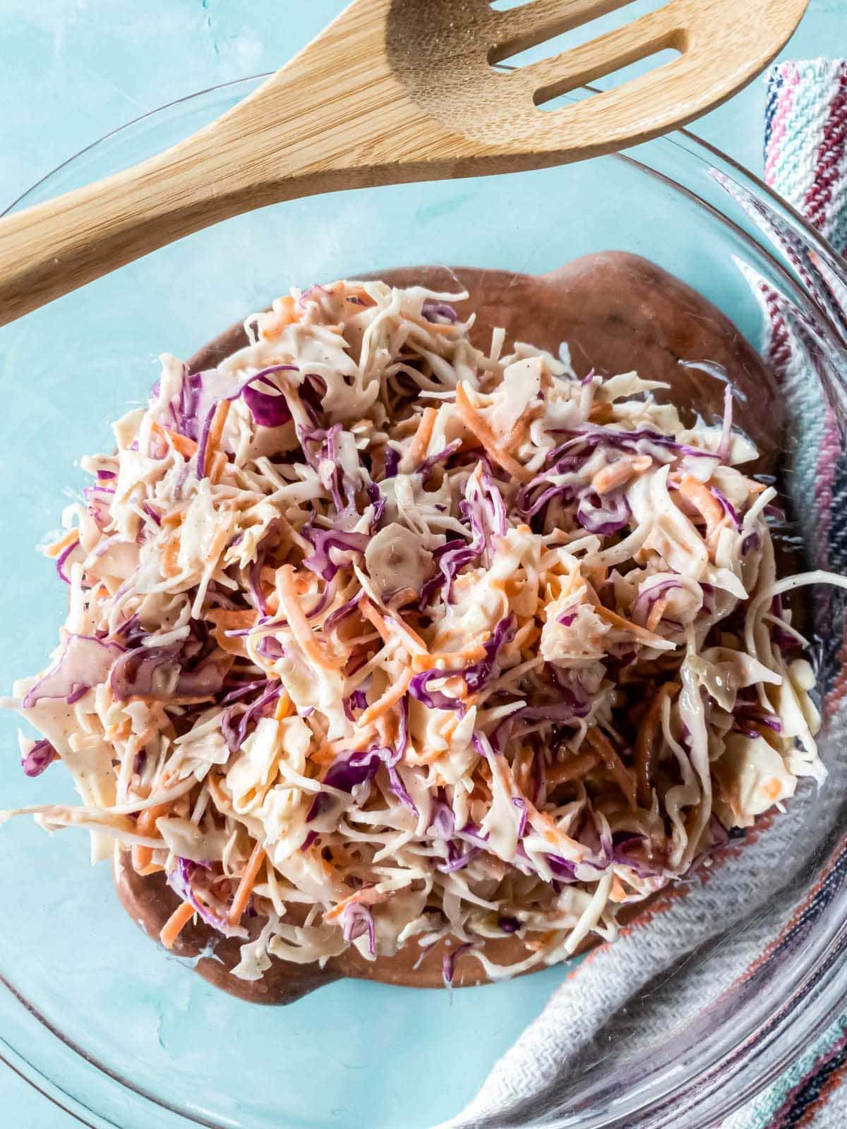 A picture of coleslaw mix tossed in creamy dressing, zoomed close.