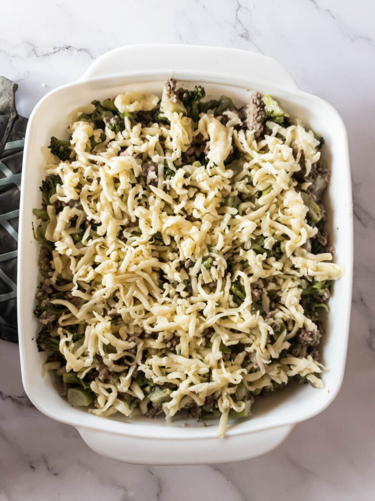 A casserole dish with hamburger meat topped with mozzarella.