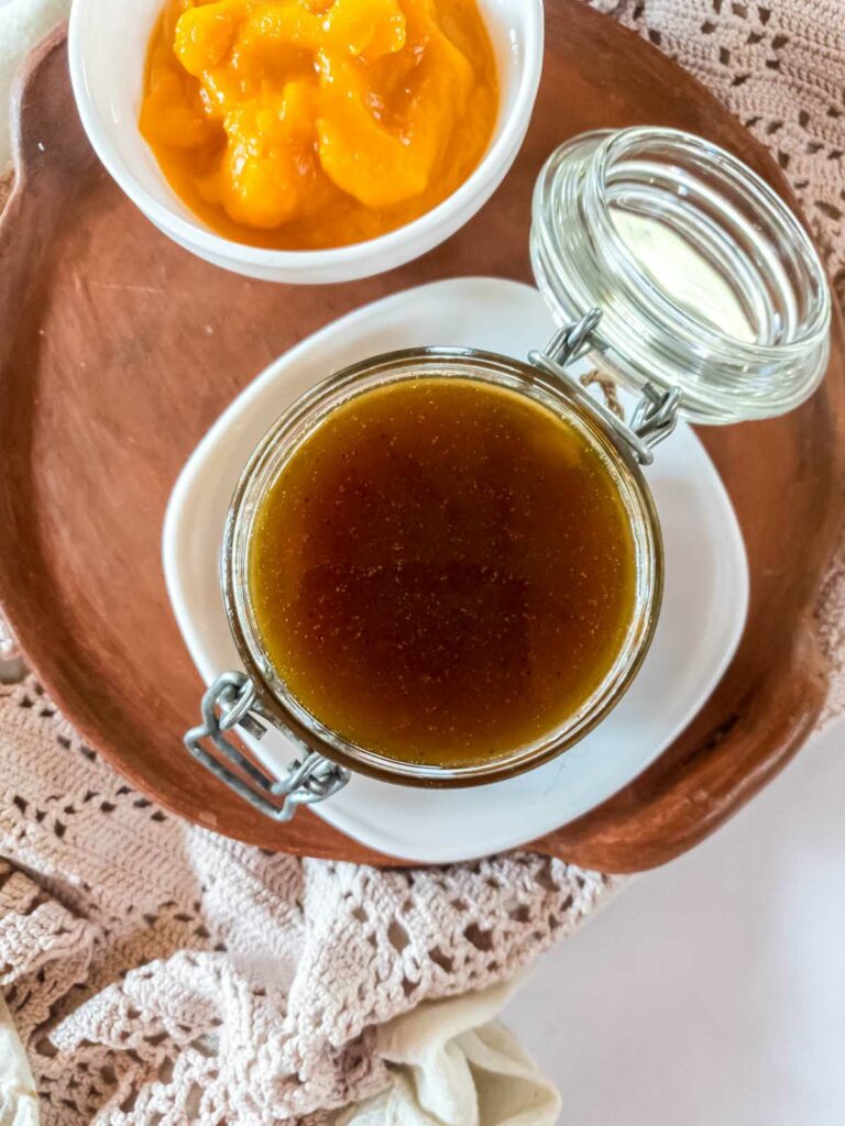 A jar of pumpkin syrup and a bowl of pumpkin puree.