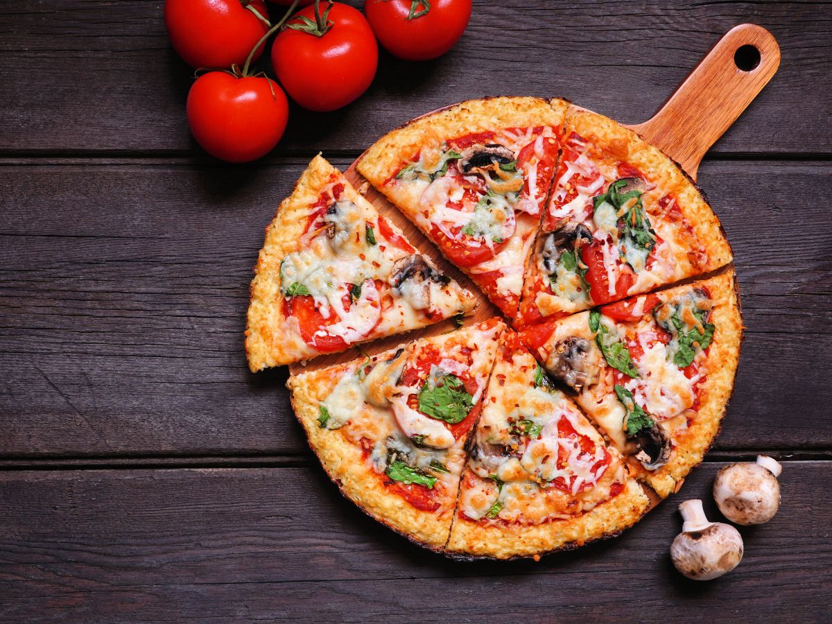 Gluten free pizza on a cutting board.