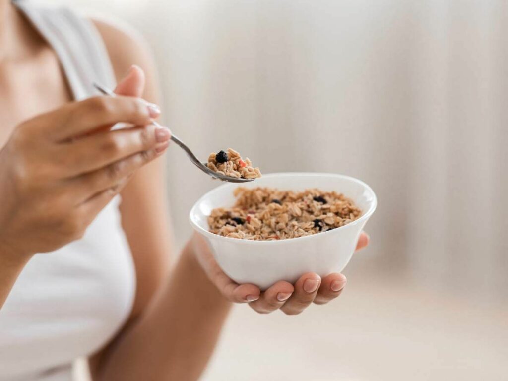 A woman is holding a bowl of oatmeal.