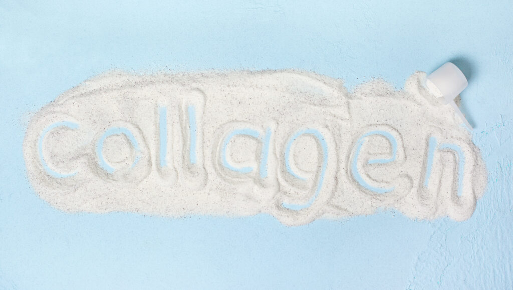 A spilled heap of powder with the word "collagen" written in it, alongside an overturned container.