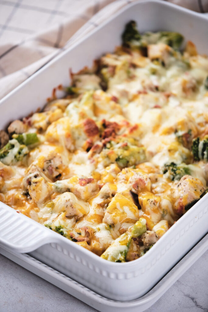 Baked chicken and broccoli casserole topped with melted cheese.