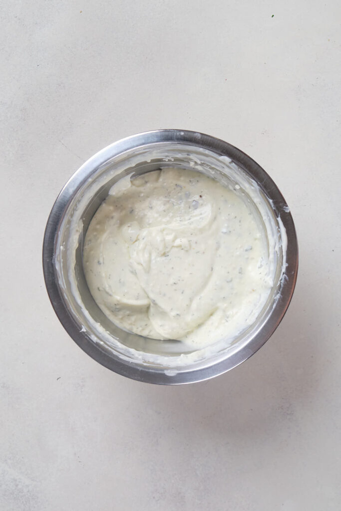A stainless steel bowl filled with creamy white dip.