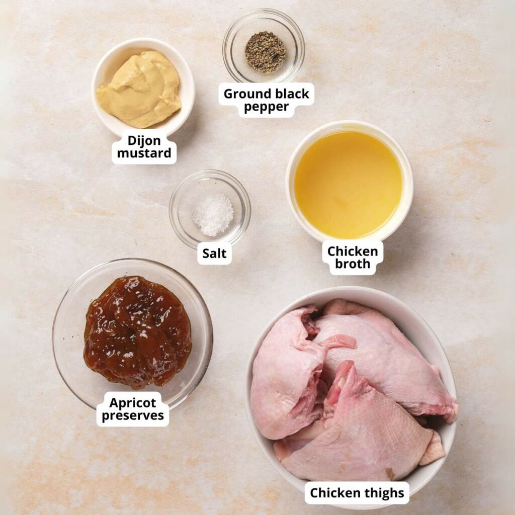 Ingredients for apricot chicken are laid out on a light colored surface.