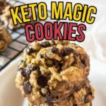 A stack of chocolate chip cookies on a plate with a cooling rack in the background. Text reads: "Easy Delicious Keto Magic Cookies.