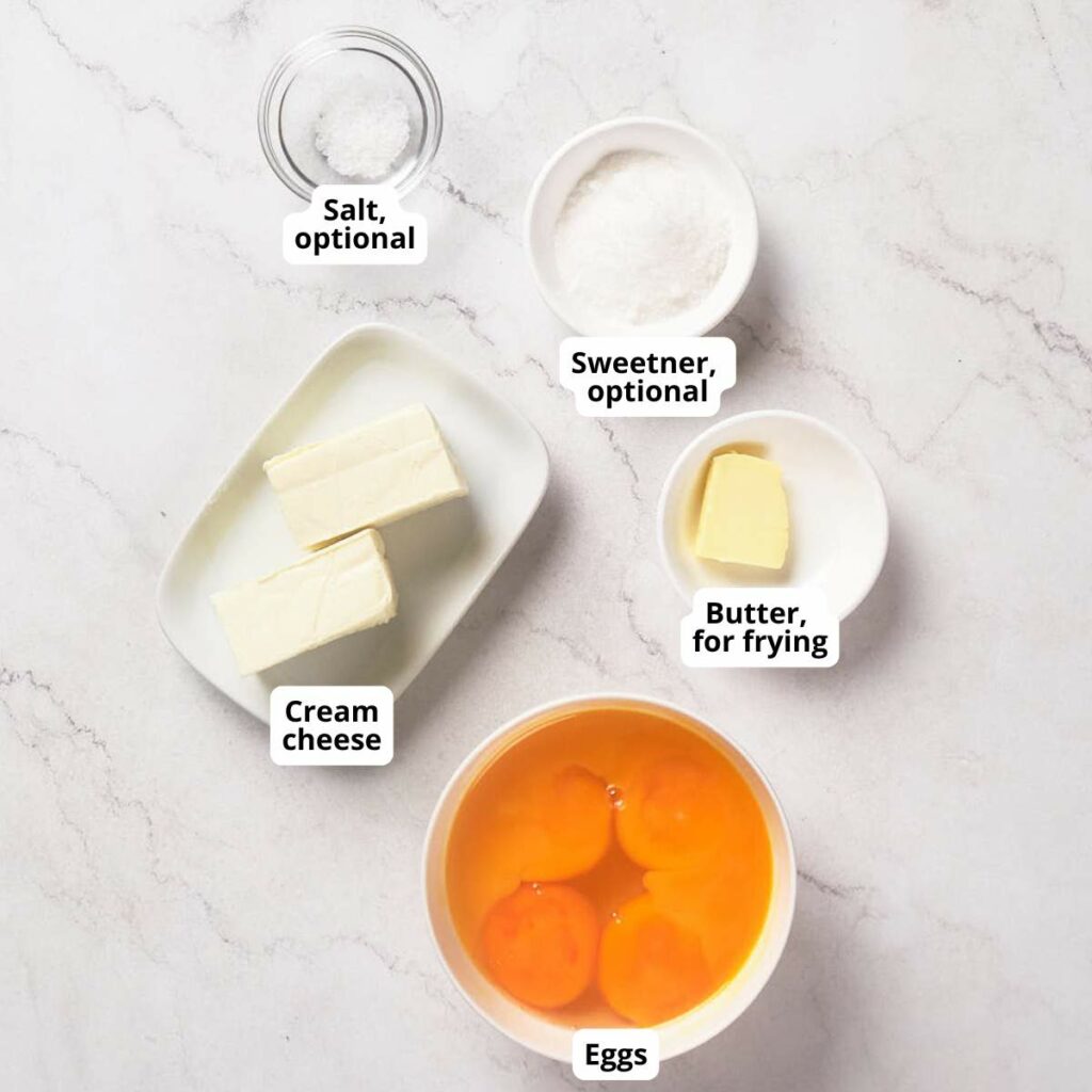 Ingredients on a marble surface include cream cheese, eggs, butter for frying, with optional salt and sweetener.