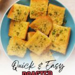 Plate with several slices of roasted garlic bread garnished with herbs, viewed from above.