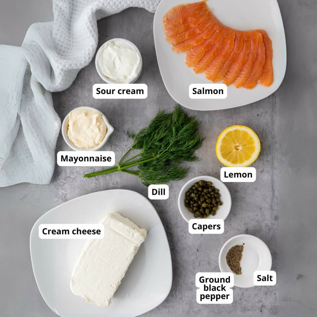 Ingredients for salmon dip laid out on a gray surface.
