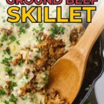 A skillet filled with cooked ground beef topped with melted cheese and parsley, with a wooden spoon scooping a portion.