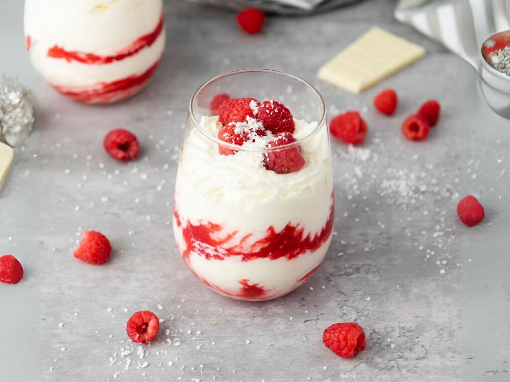 A glass of white chocolate raspberry mousse.
