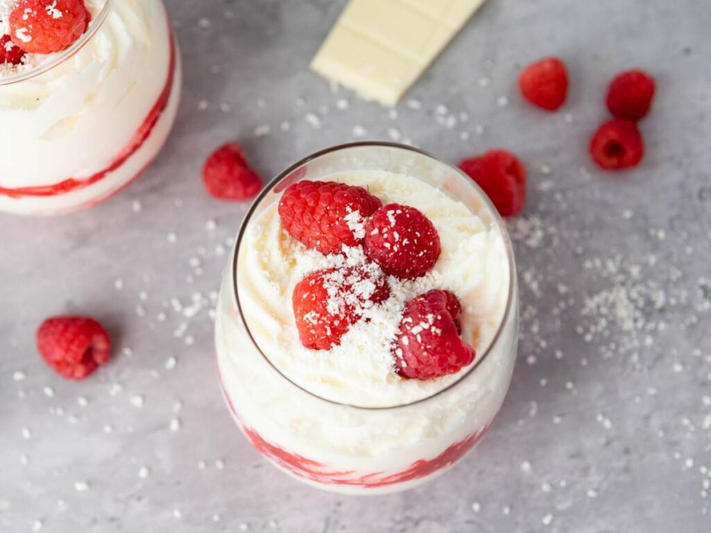 White chocolate raspberry mousse and white chocolate shavings, with more raspberries.