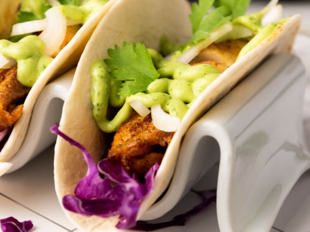 Close-up of fish tacos served in a taco holder.