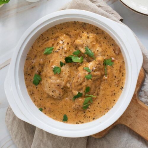 Creamy herb-seasoned marry me chicken garnished with fresh parsley.