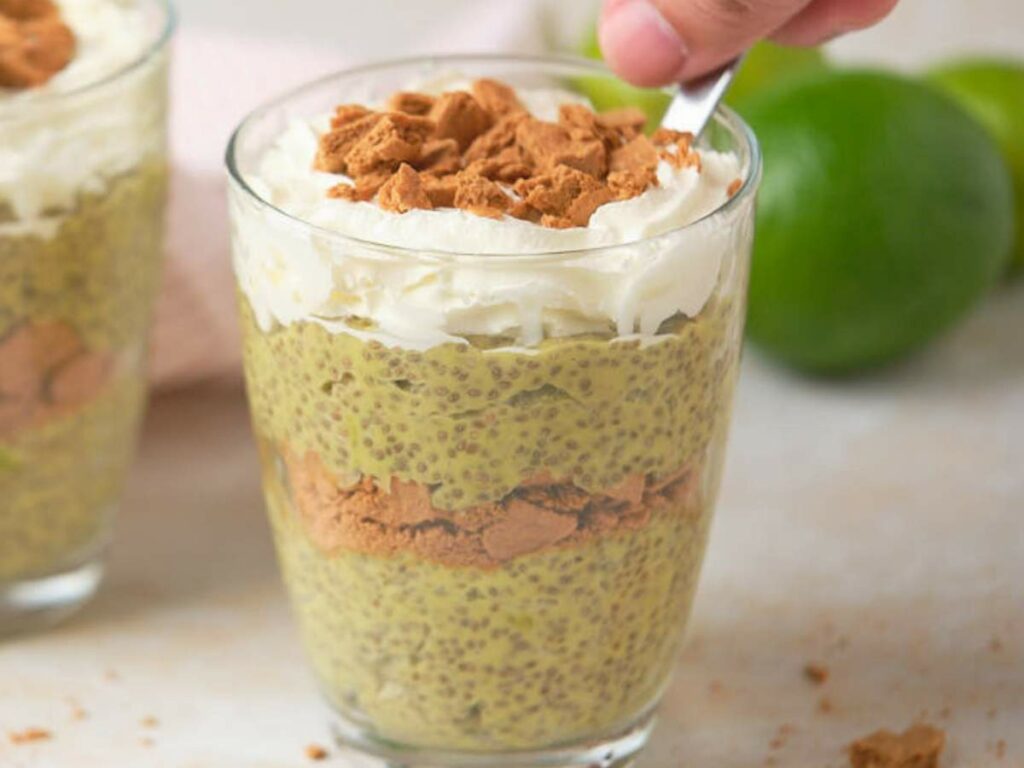 A hand scooping a spoonful of avocado chia pudding.