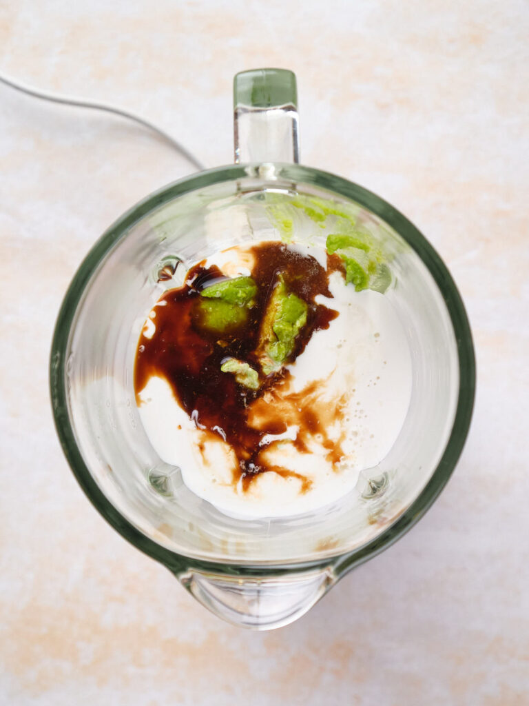 A pudding mixture in a blender, unmixed.
