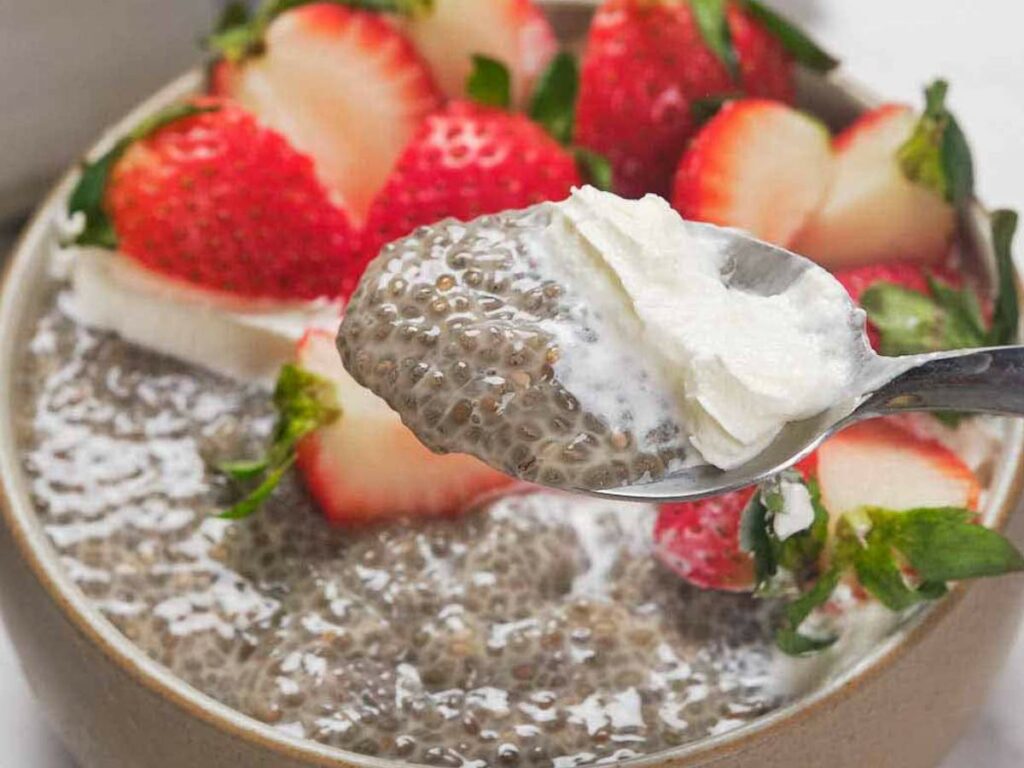 Chia pudding served with cream and strawberries.