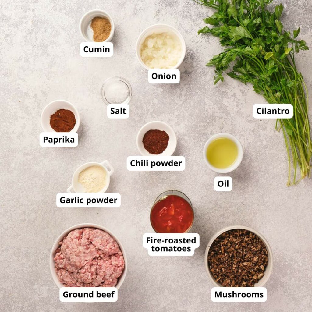 Labeled ingredients for taco meat are arranged on light countertop.