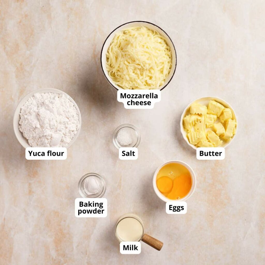 Bowls of pan de yuca ingredients arranged on a light surface.