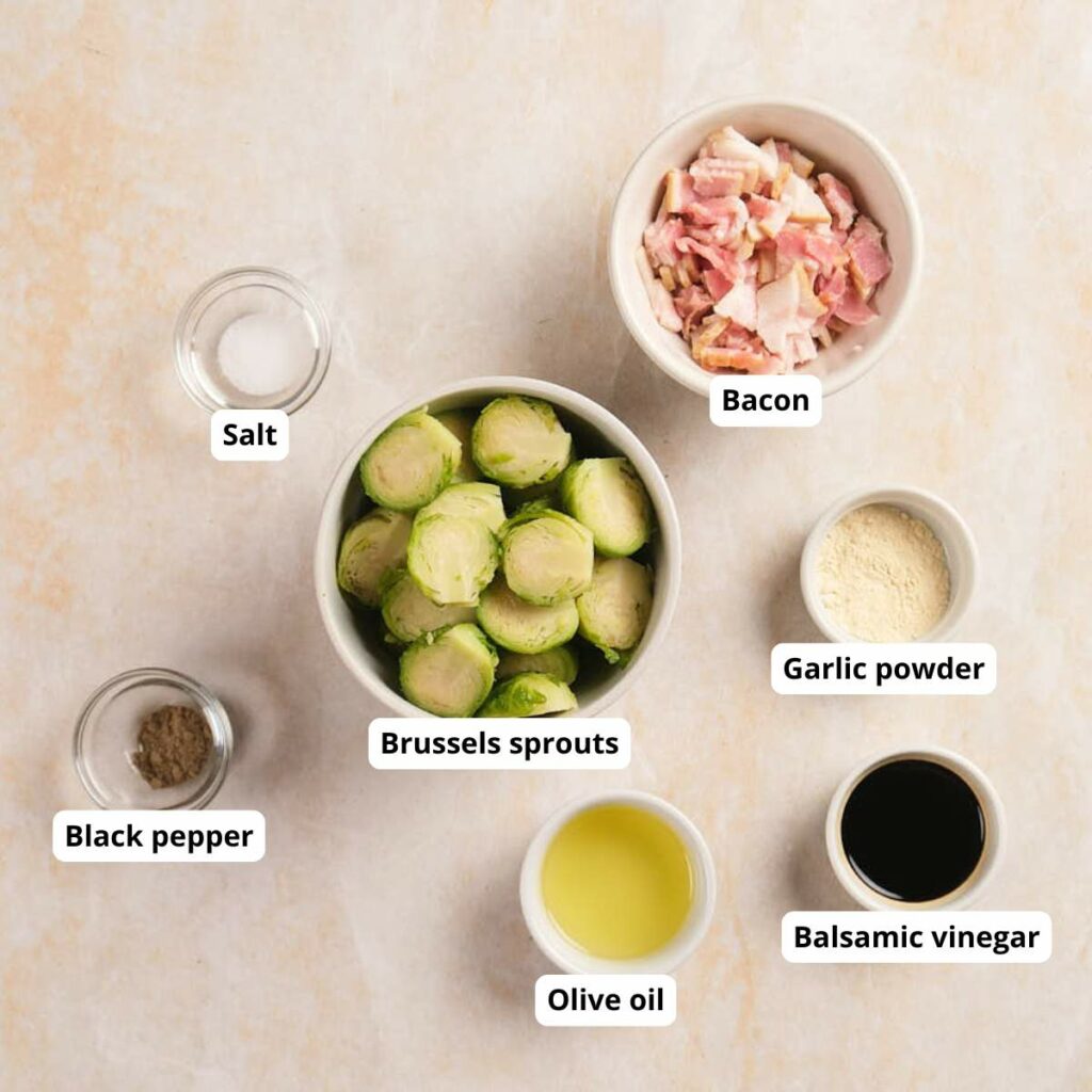 A top-down view of roasted Brussels sprouts with bacon recipe on a light surface.