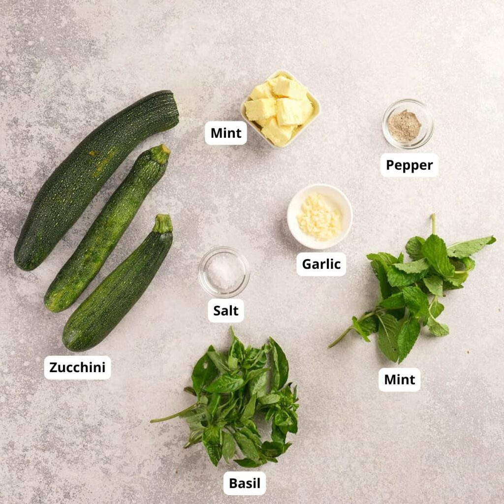 Three zucchinis, a bunch of basil, a bunch of mint, butter, minced garlic, salt, and pepper.