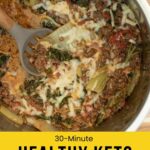 A pan of healthy keto lasagna with ground meat, cheese, tomato sauce, and vegetables.