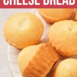 A plate of golden, round cheese bread rolls.