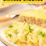 Plate of braised cabbage garnished with herbs, with a slice of casserole and a knife in the background.