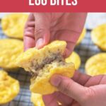Hands holding a split open carnivore egg bite, revealing a meat filling, with more egg bites on a cooling rack in the background. Text overlay reads "Carnivore Egg Bites.
