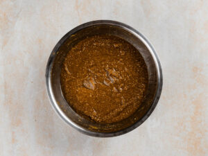 A metal bowl filled with a thick, textured brown mixture.