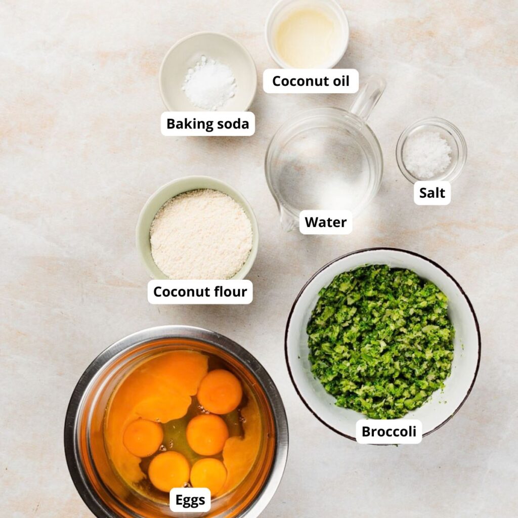 Ingredients for a recipe, including eggs, broccoli, coconut flour, baking soda, coconut oil, water, and salt, labeled with their names.